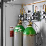 What are the different types of valves used on medical oxygen cylinders?