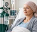 A cancer patient receiving oxygen therapy in a hospital bed